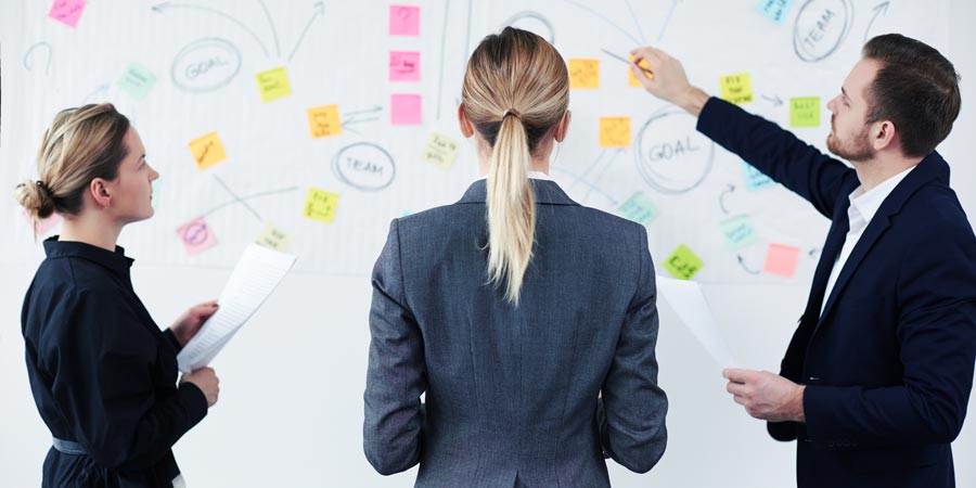 Two women and man event planning