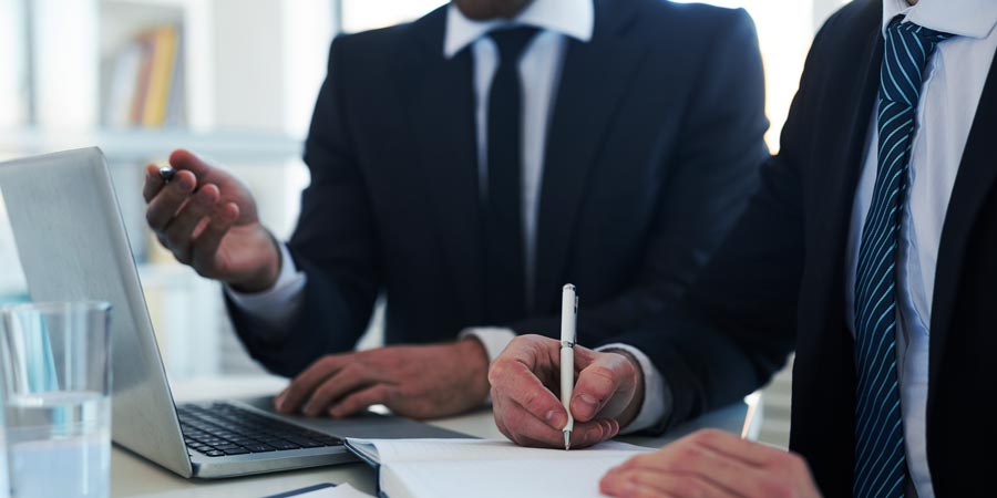 Two men listening & watching webinar