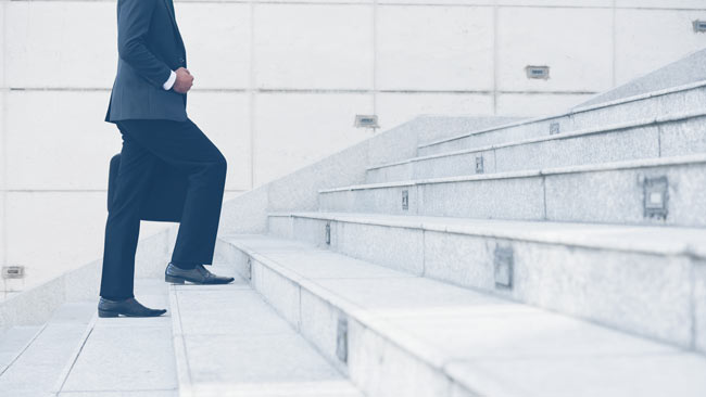 Man walking up stairs to his job Man walking up stairs to his job